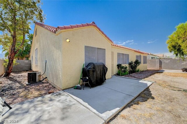 back of house with central AC and a patio area