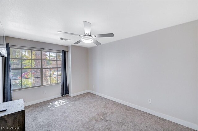 unfurnished room featuring ceiling fan and carpet floors