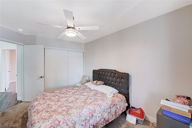 carpeted bedroom with ceiling fan and a closet