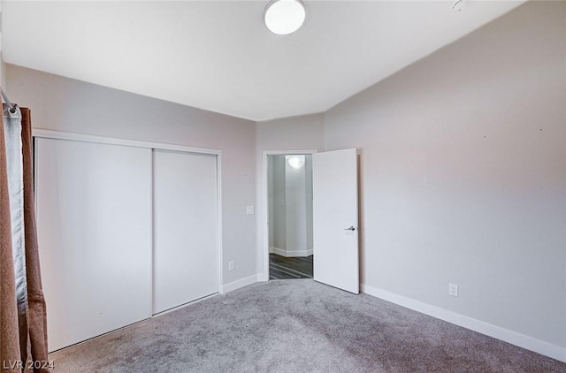 unfurnished bedroom featuring carpet and a closet