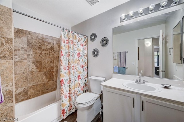 full bathroom with hardwood / wood-style flooring, vanity, toilet, and shower / tub combo