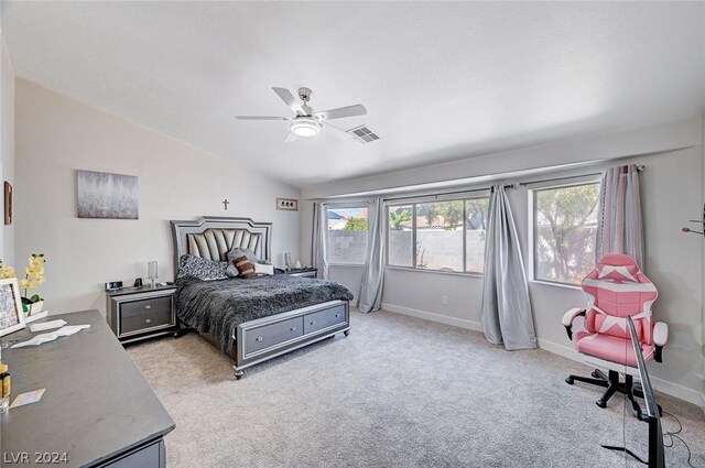 bedroom with ceiling fan, lofted ceiling, light carpet, and multiple windows