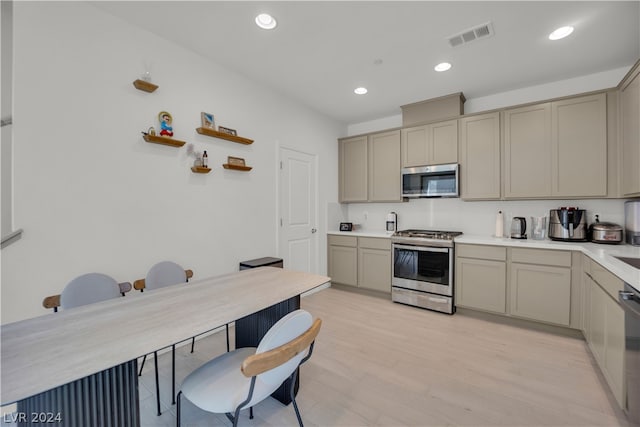 kitchen with stainless steel appliances and light hardwood / wood-style flooring