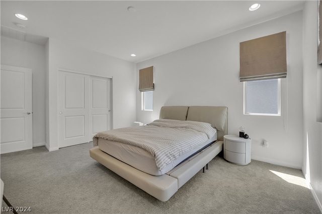 carpeted bedroom with a closet