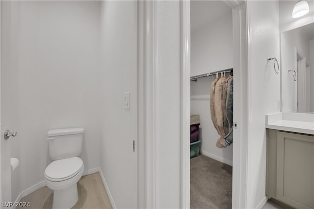 bathroom featuring toilet and vanity