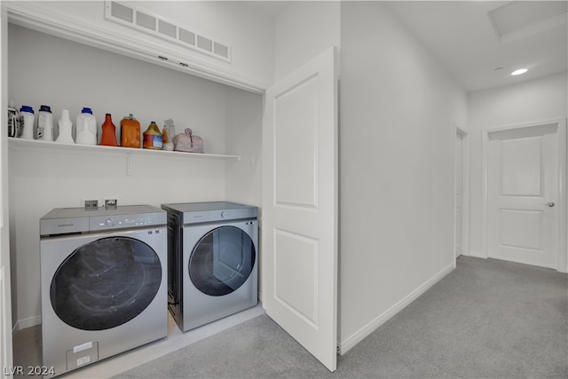 laundry room featuring light colored carpet, hookup for a washing machine, and washing machine and clothes dryer