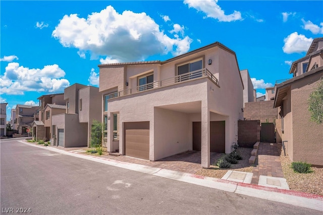 view of front of house with a garage and a balcony