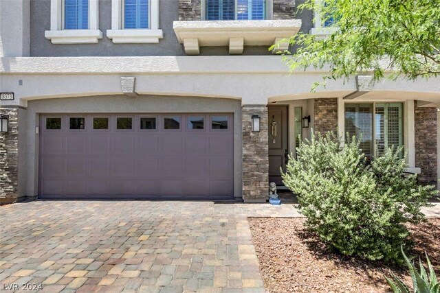 8373 Bartholomew Park Ct, Las Vegas, NV 89139 - exterior space featuring an attached garage, stucco siding, decorative driveway, and stone siding