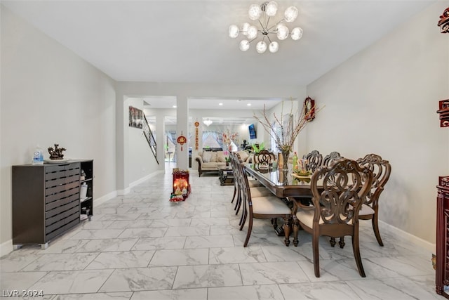 tiled dining space with a chandelier