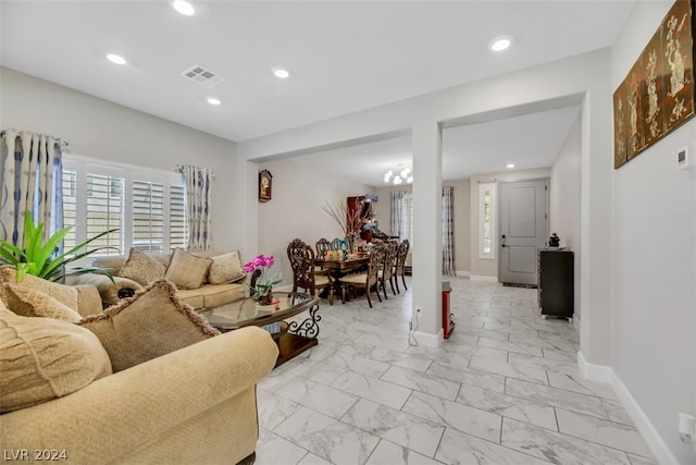 living room featuring a notable chandelier and light tile flooring