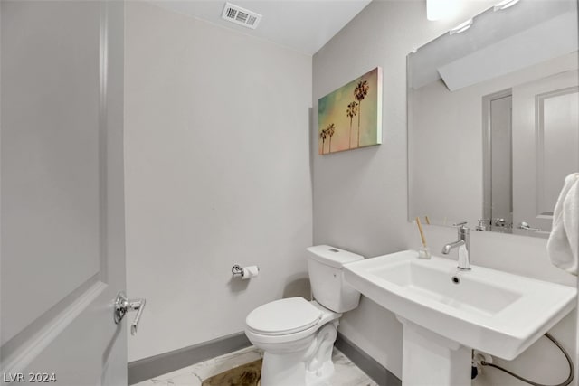 bathroom with tile floors and toilet