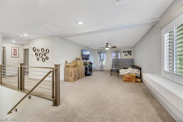 interior space featuring a wealth of natural light, carpet flooring, and ceiling fan