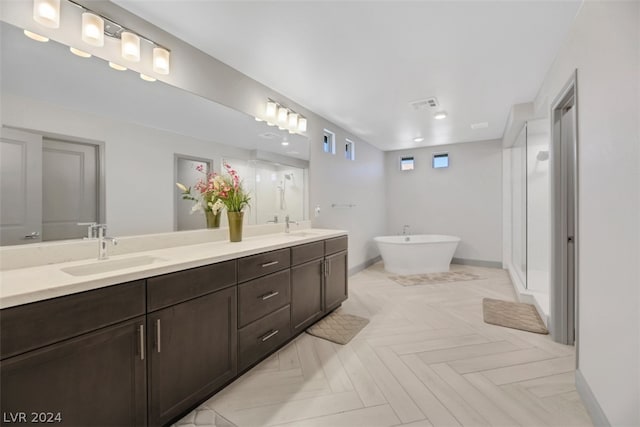 bathroom featuring an enclosed shower, double sink vanity, and parquet flooring