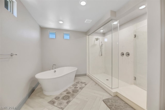 bathroom featuring tile floors and plus walk in shower