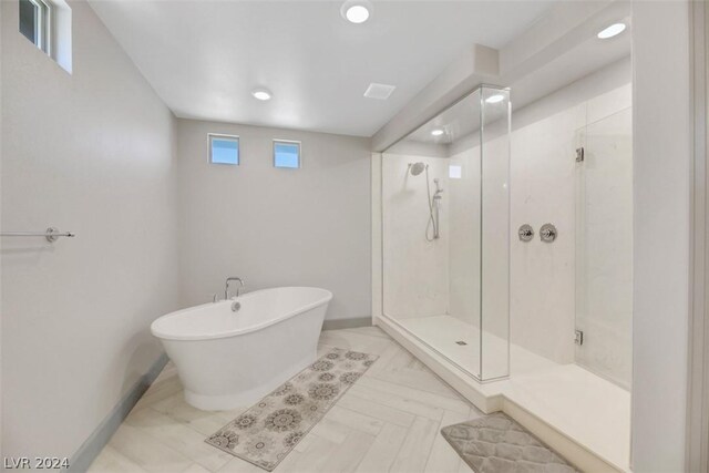 8373 Bartholomew Park Ct, Las Vegas, NV 89139 - bathroom with a stall shower, a soaking tub, baseboards, and recessed lighting