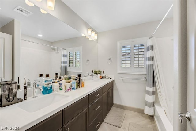 8373 Bartholomew Park Ct, Las Vegas, NV 89139 - full bath featuring a shower with curtain, baseboards, visible vents, a sink, and double vanity