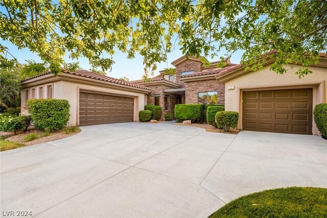 mediterranean / spanish house with a garage