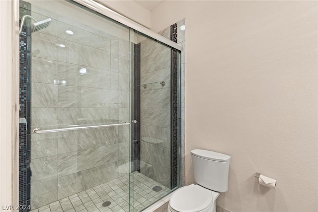 bathroom featuring walk in shower and toilet