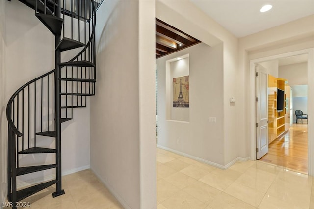 stairs featuring beam ceiling and tile patterned floors