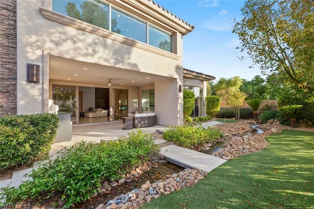 rear view of house featuring a yard, an outdoor hangout area, and a patio area