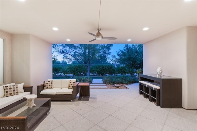 patio terrace at dusk featuring an outdoor living space and ceiling fan