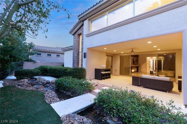 exterior space featuring an outdoor hangout area and a patio