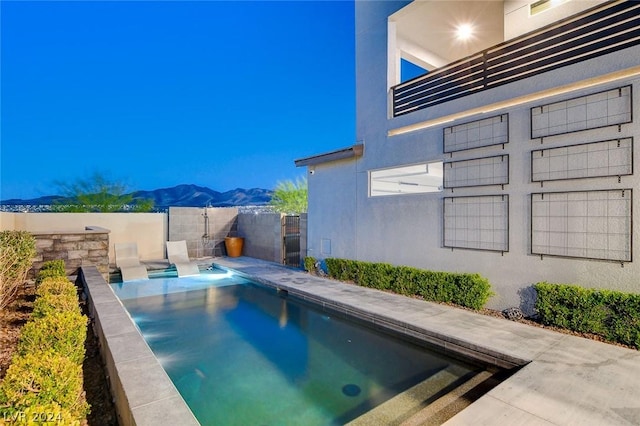 view of swimming pool featuring a mountain view and a patio area