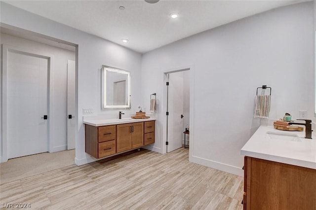 bathroom with hardwood / wood-style floors and vanity