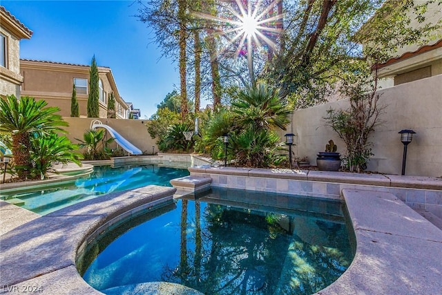 view of pool featuring a water slide