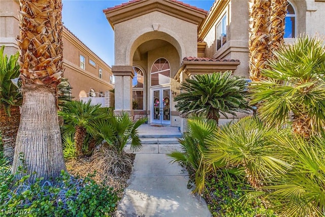 view of exterior entry featuring french doors