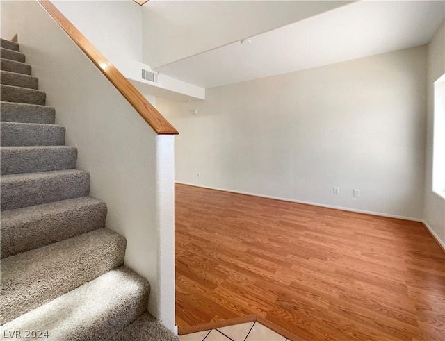 stairway featuring hardwood / wood-style floors