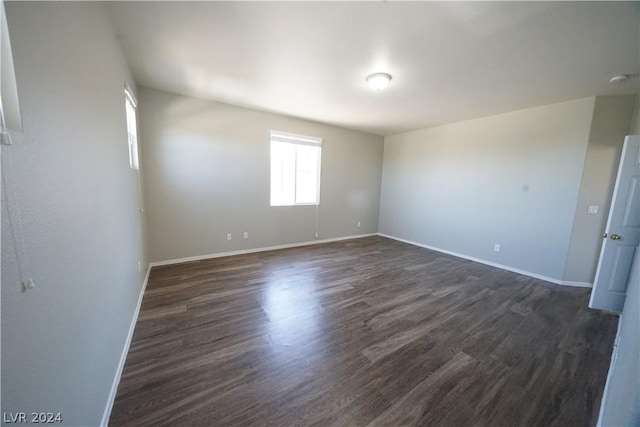 empty room featuring dark hardwood / wood-style flooring