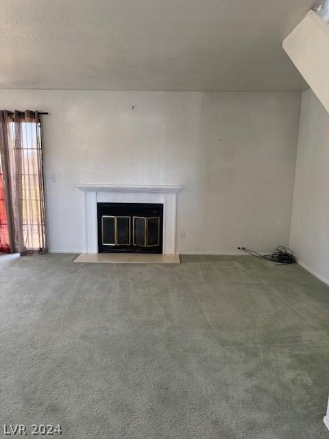 unfurnished living room with carpet