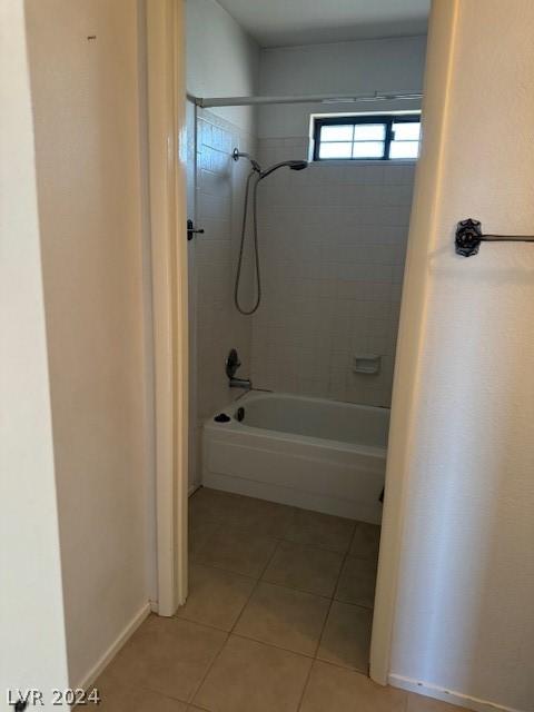 bathroom with tiled shower / bath and tile flooring