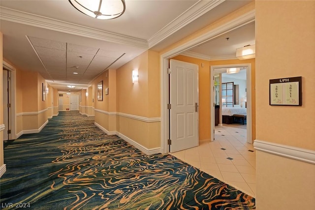 corridor featuring tile patterned floors and ornamental molding