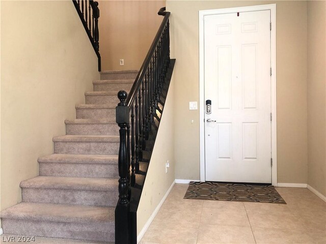 entryway with light tile patterned floors