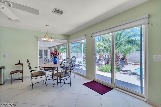 tiled dining area with ceiling fan