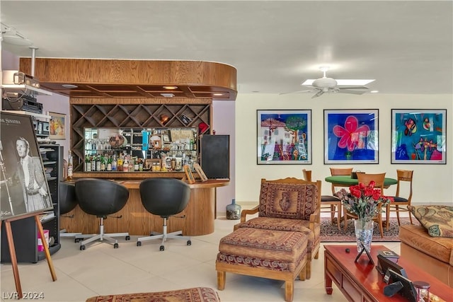 bar featuring ceiling fan and light tile patterned flooring