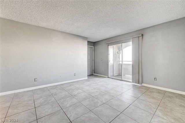 unfurnished room with a textured ceiling