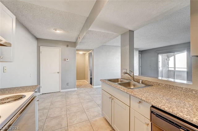 kitchen featuring sink, stainless steel dishwasher, a textured ceiling, and light tile patterned flooring