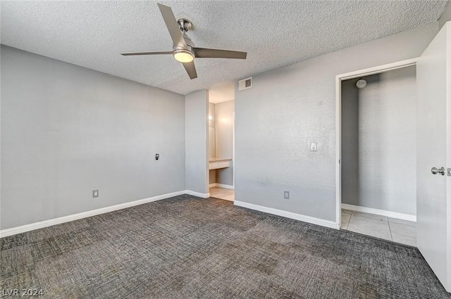 unfurnished bedroom with a textured ceiling, ceiling fan, and carpet flooring