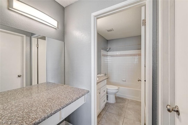 full bathroom with tile patterned floors, vanity, toilet, and tiled shower / bath combo