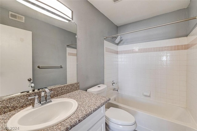 full bathroom featuring vanity, bathing tub / shower combination, and toilet