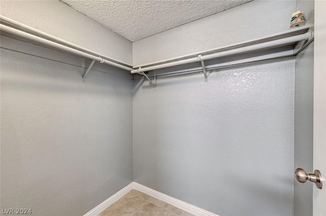 walk in closet featuring tile patterned flooring