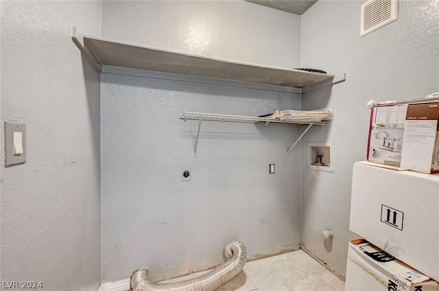 washroom with light tile patterned flooring, washer hookup, and hookup for an electric dryer