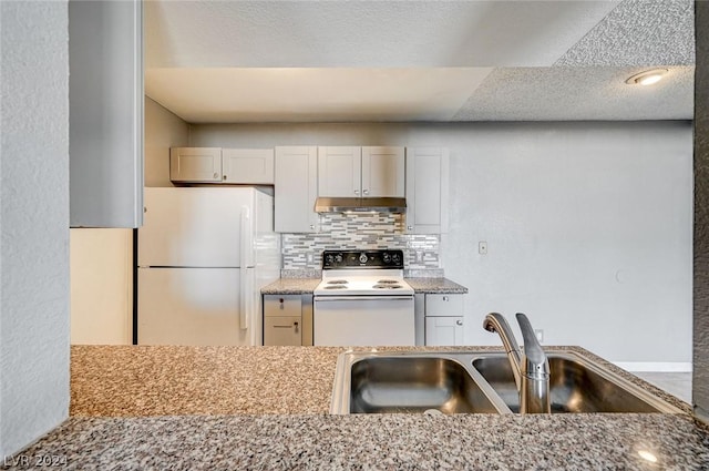 kitchen with sink, tasteful backsplash, white appliances, light stone countertops, and white cabinets