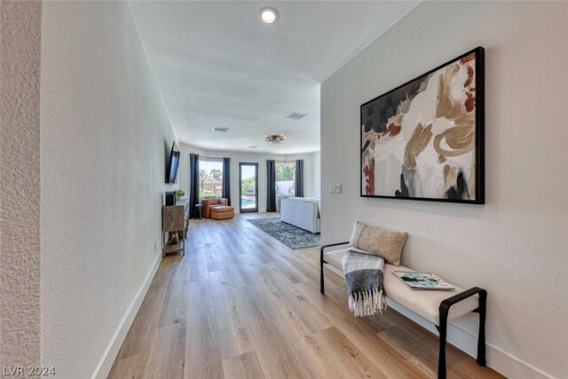 corridor with light hardwood / wood-style floors