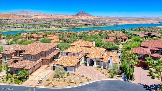 drone / aerial view with a water and mountain view