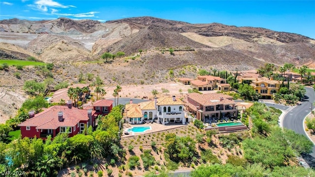 birds eye view of property with a mountain view