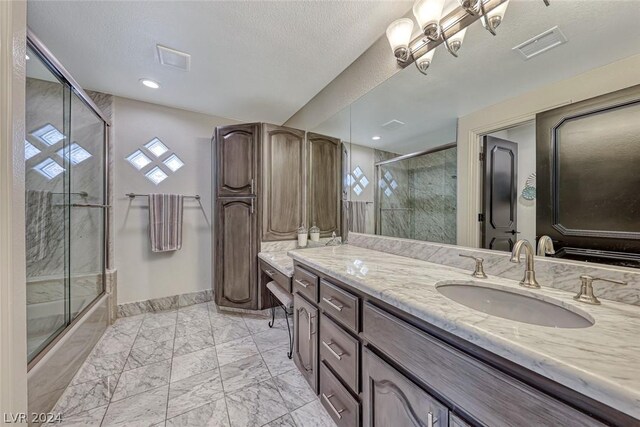 bathroom with vanity, a textured ceiling, and tile floors